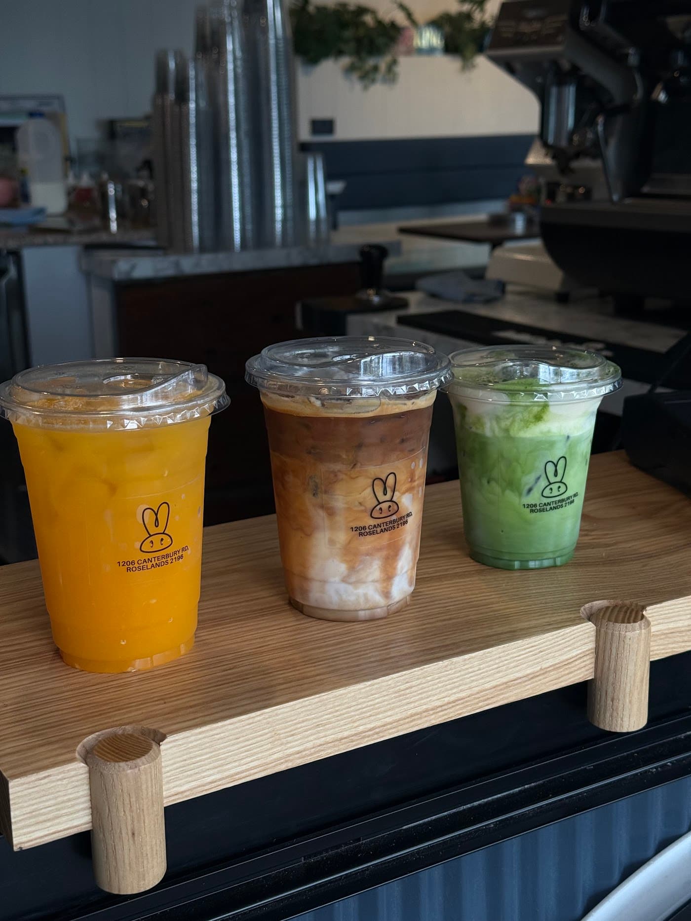 Three refreshing iced beverages on a wooden display